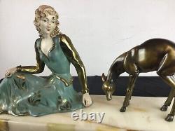 Important Art Deco sculpture representing a woman nurturing a deer