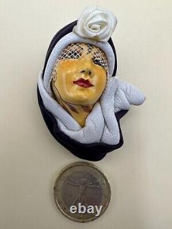 Vintage woman's brooch with a ceramic and leather hat in Art Deco style.